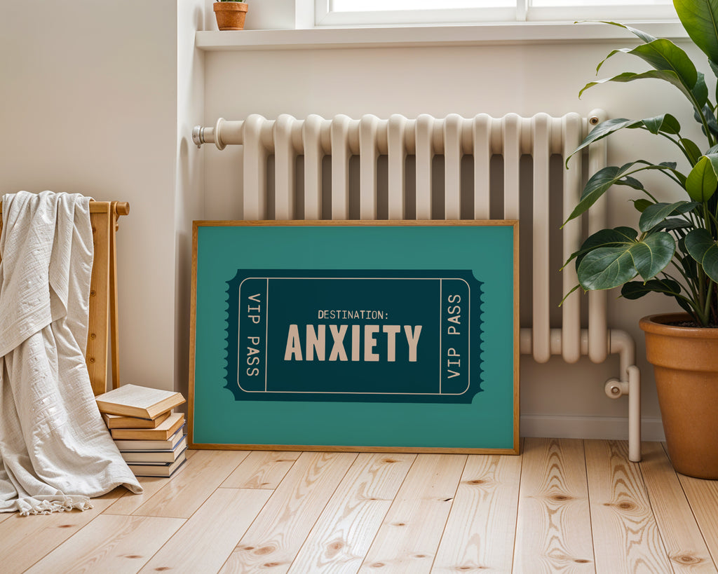 Framed artwork with 'Destination: Anxiety' text in a room with a radiator and plant.