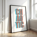 Framed artwork with the word 'CHAOTIC' in a 3D effect on a white wall.