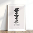 Framed artwork with a stylized design on a white wall.