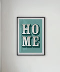 Framed artwork with 'HOME' text on a light gray wall