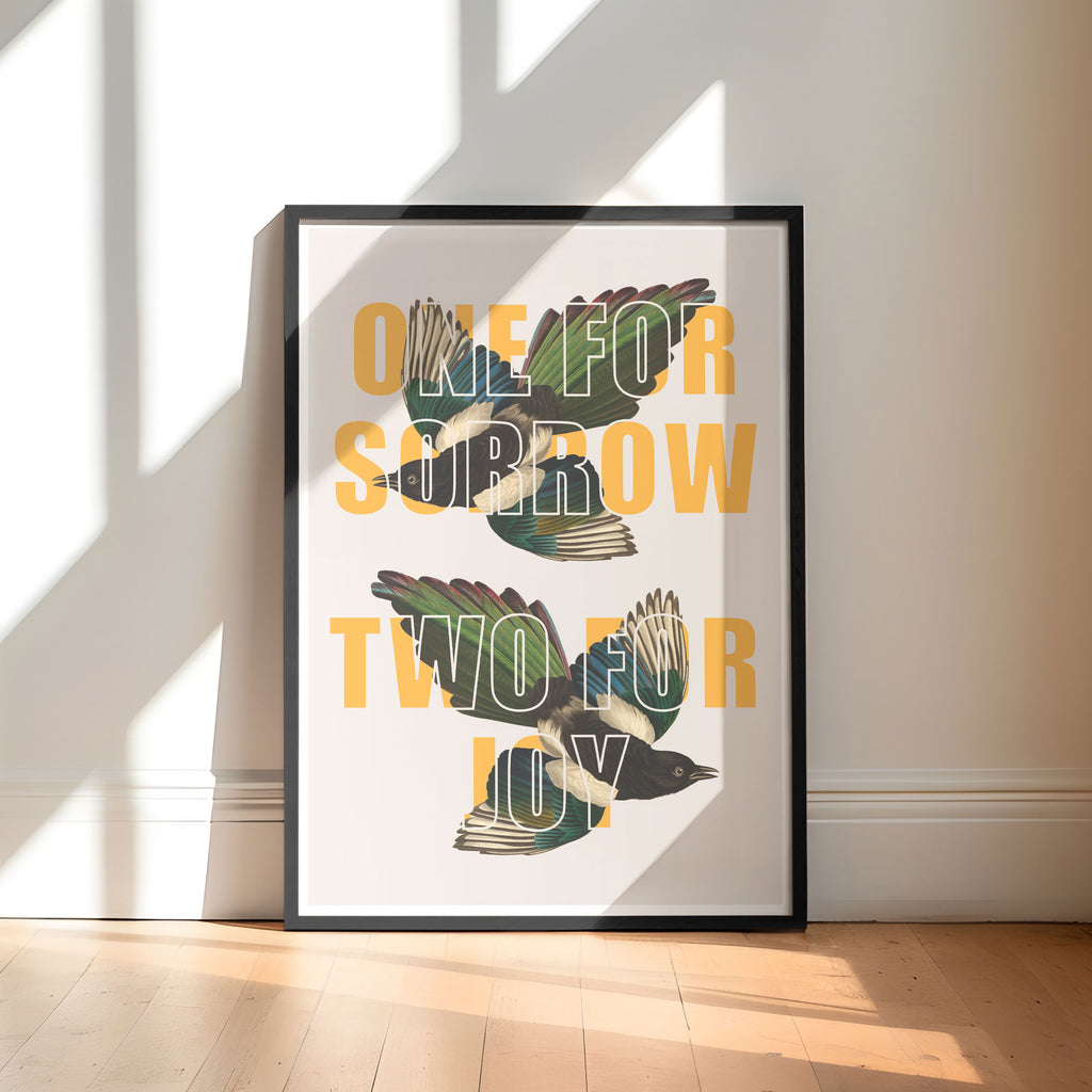 A print with the saying 'One For Sorrow, Two For Joy' overlaid on two vintage magpie drawings. 