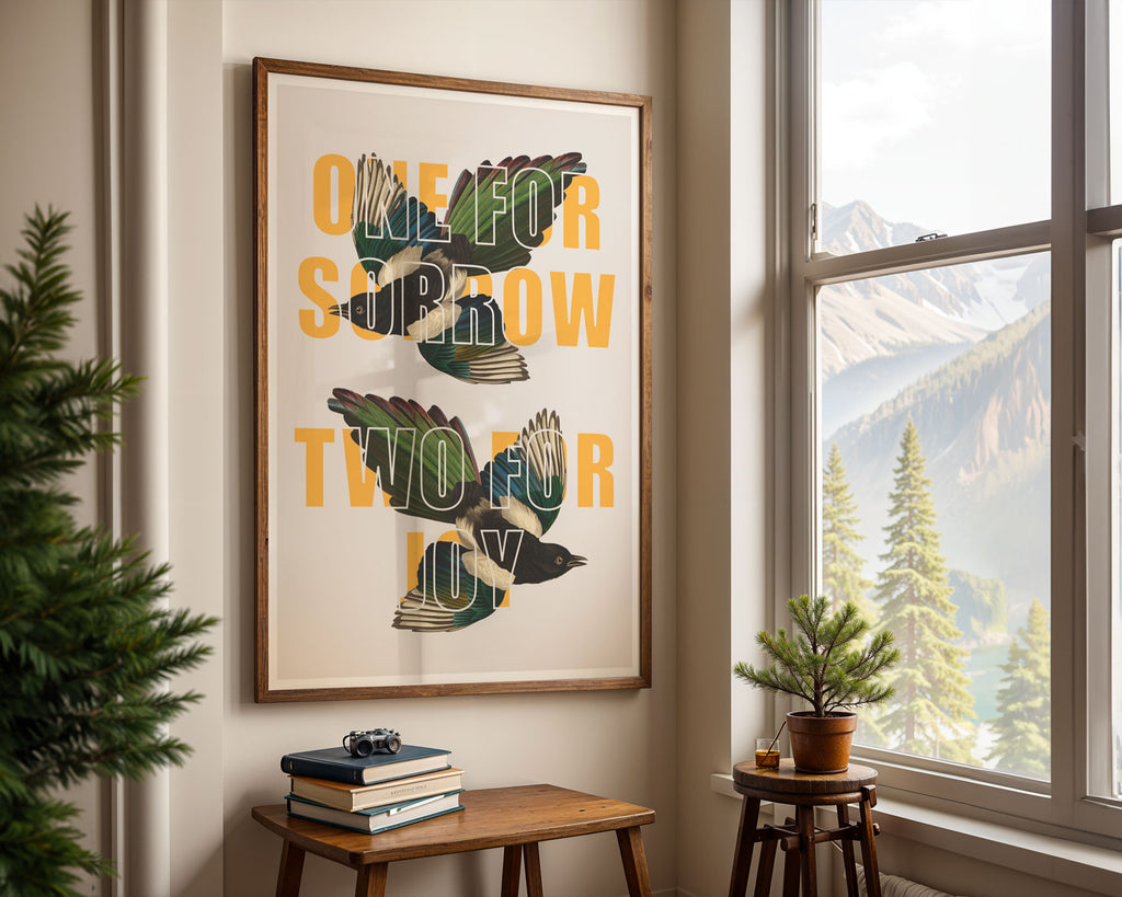 A print with the saying 'One For Sorrow, Two For Joy' overlaid on two vintage magpie drawings. 