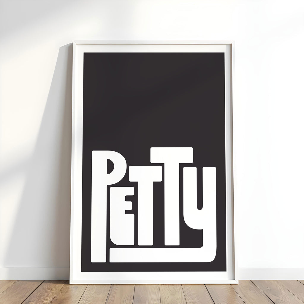 Framed artwork with the word 'Petty' on a black background