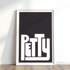 Framed artwork with the word 'Petty' on a black background