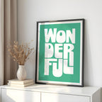 Framed artwork with 'WONDERFUL' text on a white surface with decorative items.