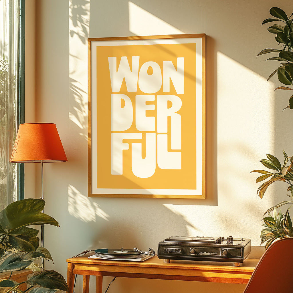 Framed artwork with 'WONDERFUL' text in a room with plants and a lamp.